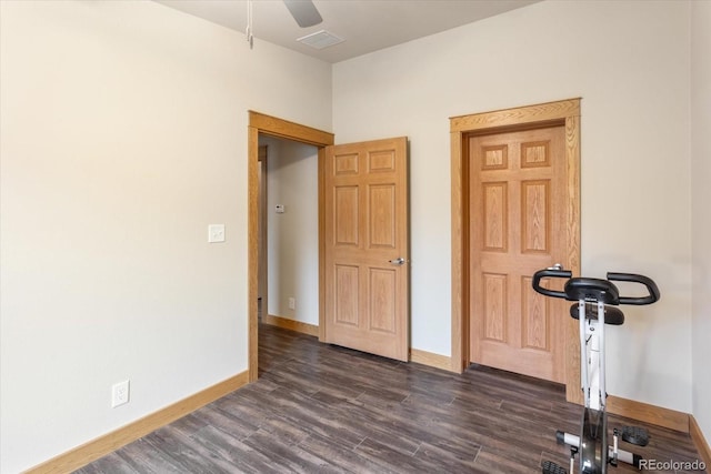 workout area featuring a ceiling fan, baseboards, visible vents, and dark wood-style floors