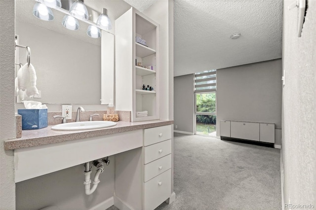 2500 S York St Unit 116, Denver, CO 80210 - bathroom featuring a textured ceiling and vanity