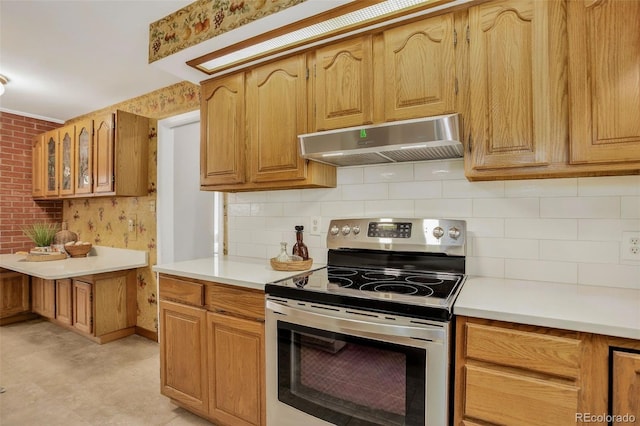 2920 S York St, Denver, CO 80210 - kitchen featuring under cabinet range hood, electric range, light countertops, decorative backsplash, and glass insert cabinets
