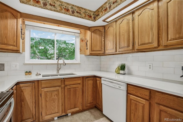 2920 S York St, Denver, CO 80210 - kitchen with dishwasher, brown cabinetry, backsplash, and light countertops