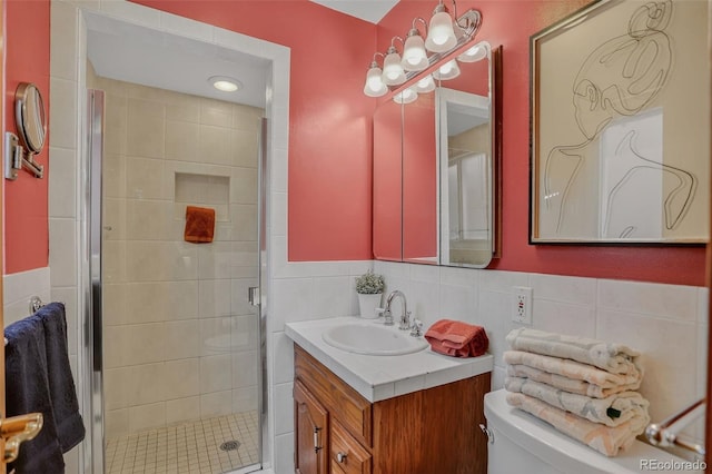 2920 S York St, Denver, CO 80210 - full bathroom with vanity, a stall shower, tile walls, and a wainscoted wall