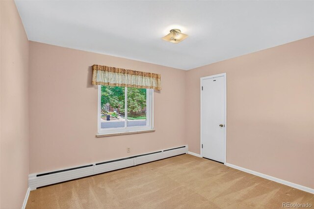 2920 S York St, Denver, CO 80210 - carpeted empty room featuring a baseboard heating unit and baseboards