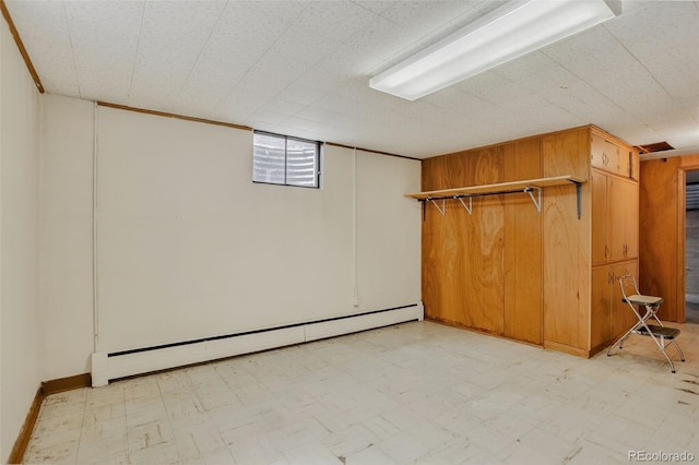 2920 S York St, Denver, CO 80210 - below grade area featuring a baseboard radiator and light floors
