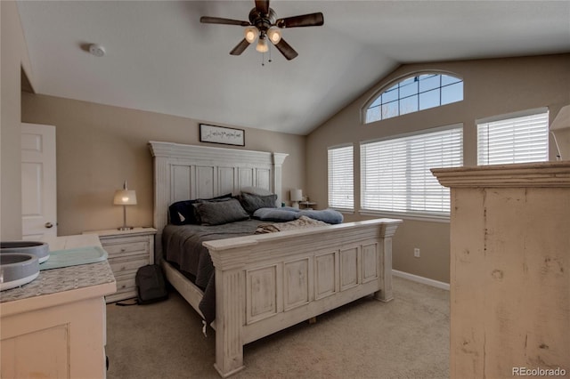 bedroom featuring vaulted ceiling, light colored carpet, and ceiling fan