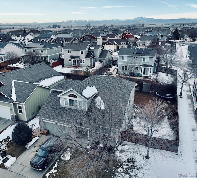 snowy aerial view featuring a mountain view