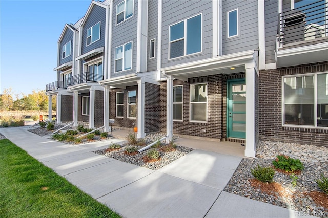 view of exterior entry featuring brick siding