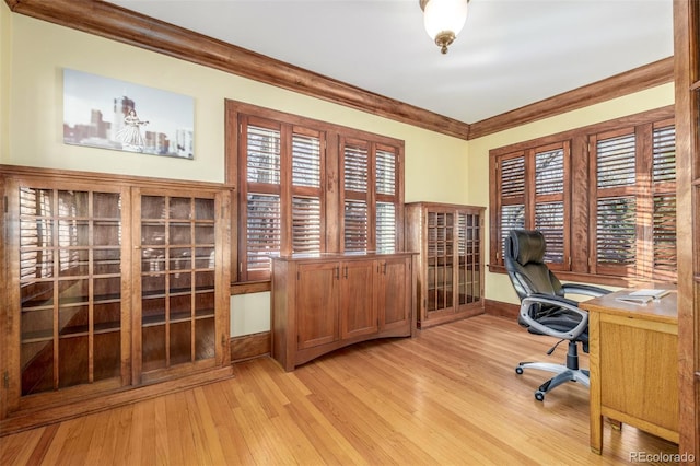 unfurnished office featuring crown molding, plenty of natural light, and light hardwood / wood-style flooring