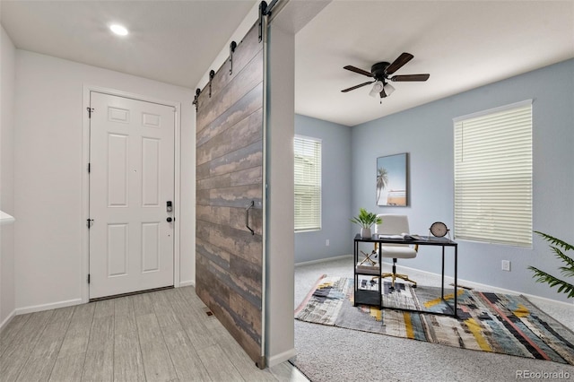 4343 S Nepal Ct, Centennial, CO 80015 - foyer with a barn door, a ceiling fan, and wood finished floors