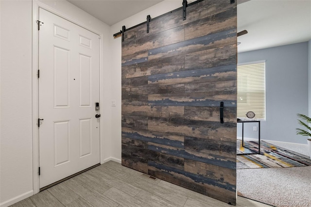 4343 S Nepal Ct, Centennial, CO 80015 - foyer featuring a barn door and wood finished floors