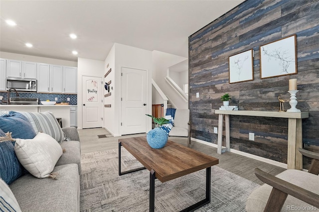 4343 S Nepal Ct, Centennial, CO 80015 - living area featuring light wood-type flooring, recessed lighting, wooden walls, and stairway