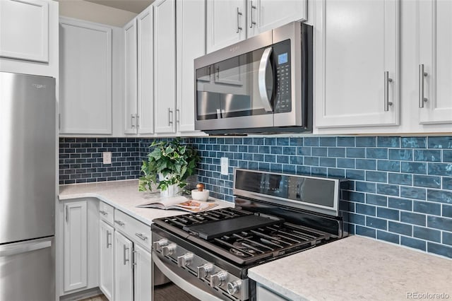 4343 S Nepal Ct, Centennial, CO 80015 - kitchen with stainless steel appliances, light countertops, white cabinets, and backsplash