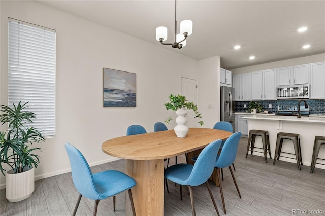4343 S Nepal Ct, Centennial, CO 80015 - dining room featuring light wood finished floors, recessed lighting, and a chandelier