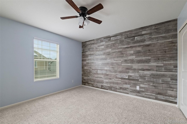 4343 S Nepal Ct, Centennial, CO 80015 - spare room featuring wooden walls, ceiling fan, carpet flooring, and an accent wall