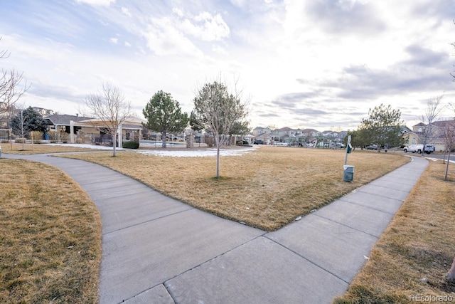 view of home's community with a residential view and a lawn