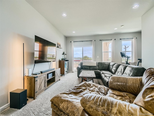 living room featuring recessed lighting, baseboards, and light colored carpet