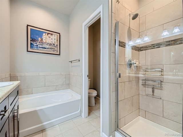 bathroom featuring a garden tub, tile patterned flooring, toilet, vanity, and a shower stall