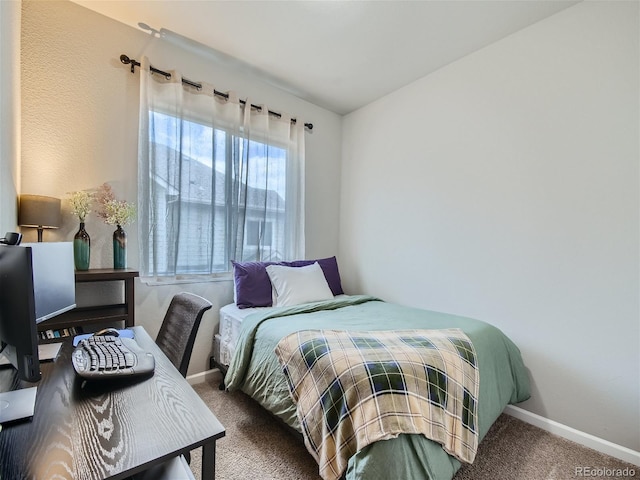 carpeted bedroom with baseboards