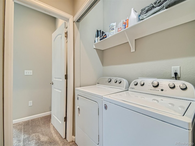 clothes washing area featuring washer and dryer, laundry area, light carpet, and baseboards