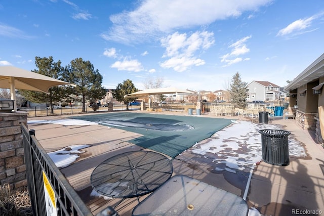 community pool with a residential view, fence, and a patio