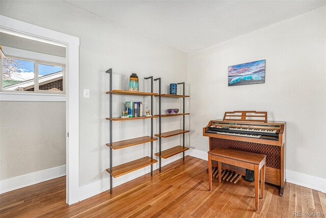 living area featuring baseboards and wood finished floors