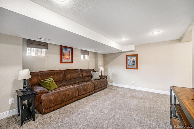 living area with carpet floors, visible vents, and baseboards