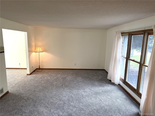 3262 S Salida Way, Aurora, CO 80013 - unfurnished room with dark colored carpet, healthy amount of natural light, and a textured ceiling
