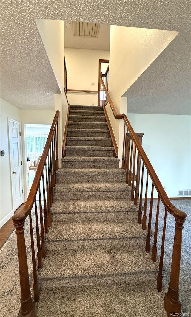 3262 S Salida Way, Aurora, CO 80013 - staircase featuring carpet floors and a textured ceiling