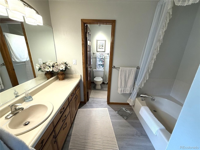 3262 S Salida Way, Aurora, CO 80013 - full bath featuring vanity, wood finished floors, and bathing tub / shower combination