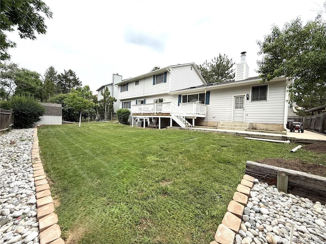 3262 S Salida Way, Aurora, CO 80013 - back of house featuring a chimney, a wooden deck, stairs, and a storage unit