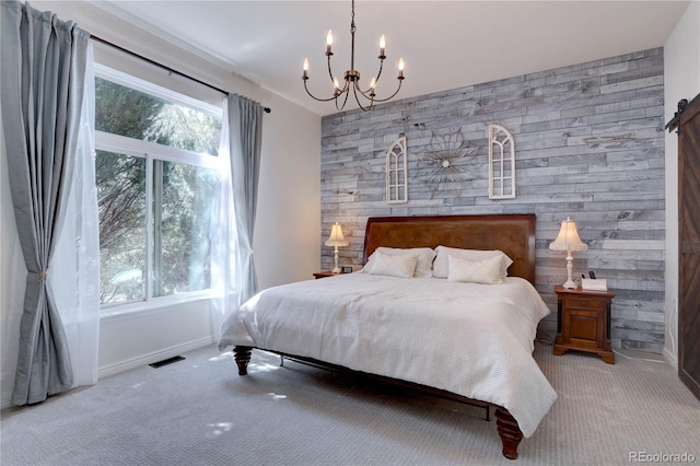 carpeted bedroom featuring visible vents, baseboards, an inviting chandelier, an accent wall, and wooden walls