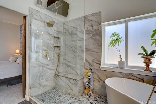 ensuite bathroom with a marble finish shower, a freestanding tub, and ensuite bath