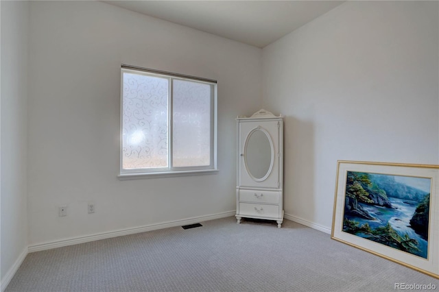 unfurnished bedroom featuring carpet flooring, visible vents, and baseboards