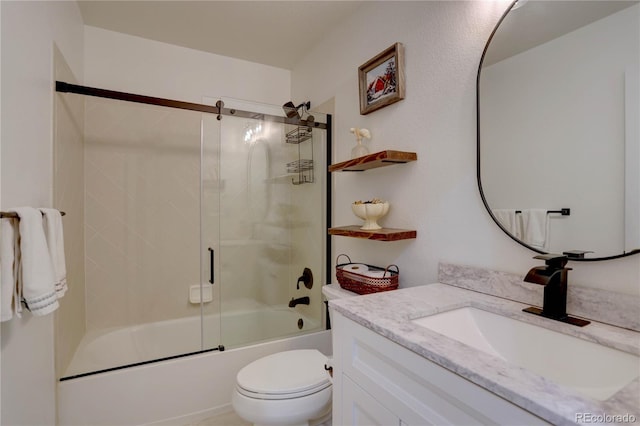 bathroom with toilet, vanity, and bath / shower combo with glass door