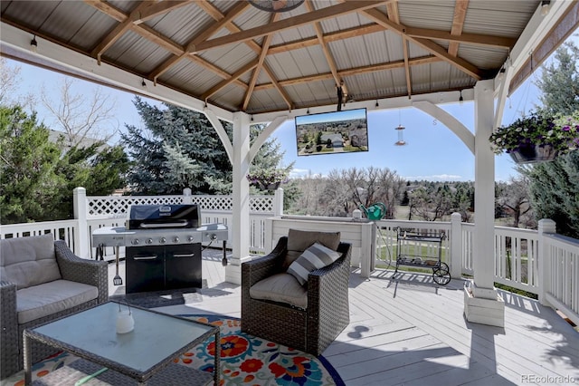 wooden deck with a gazebo, outdoor lounge area, and area for grilling