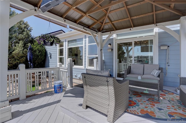wooden terrace with outdoor lounge area and a gazebo