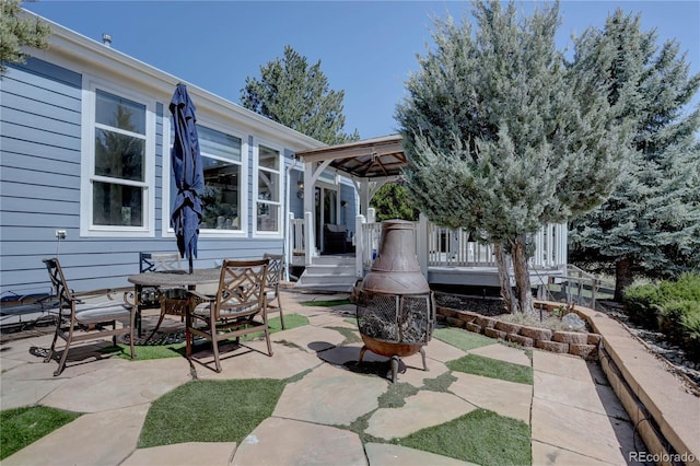 view of patio / terrace with outdoor dining space and a wooden deck