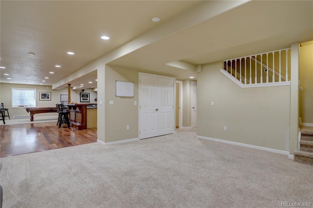 carpeted living area with recessed lighting, stairway, and baseboards