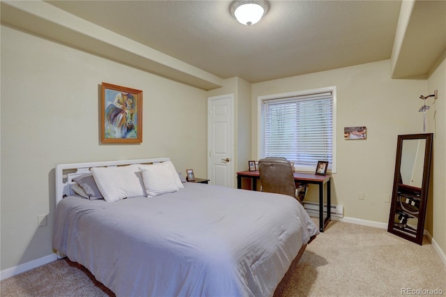 bedroom with light carpet, a baseboard heating unit, and baseboards