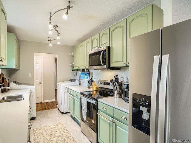 6346 Fenton St, Arvada, CO 80003 - kitchen featuring stainless steel appliances, green cabinets, and washing machine and dryer