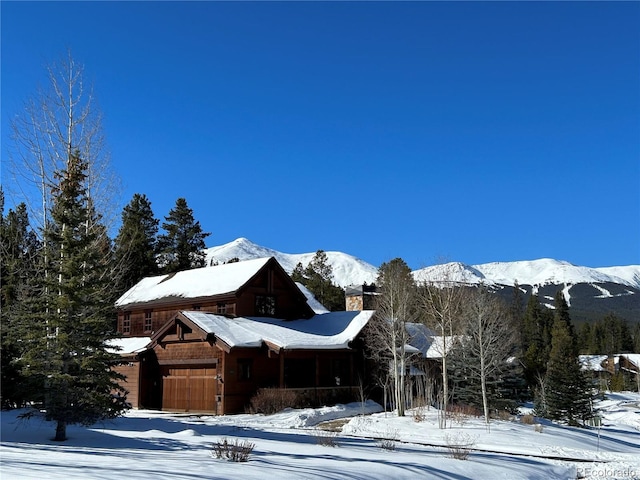 view of front of property with a mountain view and a garage