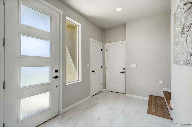 doorway to outside with light tile patterned floors and plenty of natural light