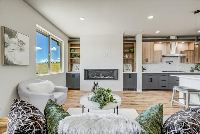 living room featuring light wood-type flooring and a fireplace