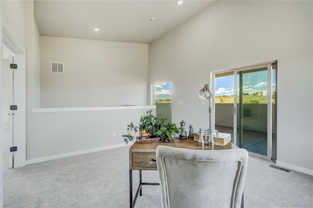 home office featuring high vaulted ceiling and light carpet