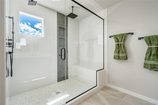 bathroom featuring a shower with door and tile patterned floors