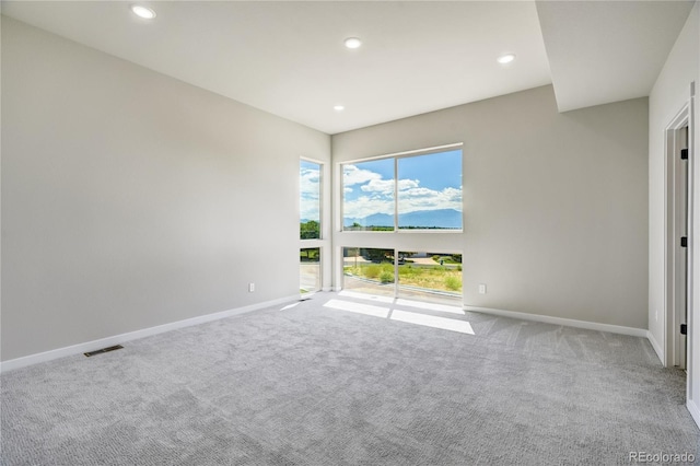 unfurnished room with light carpet