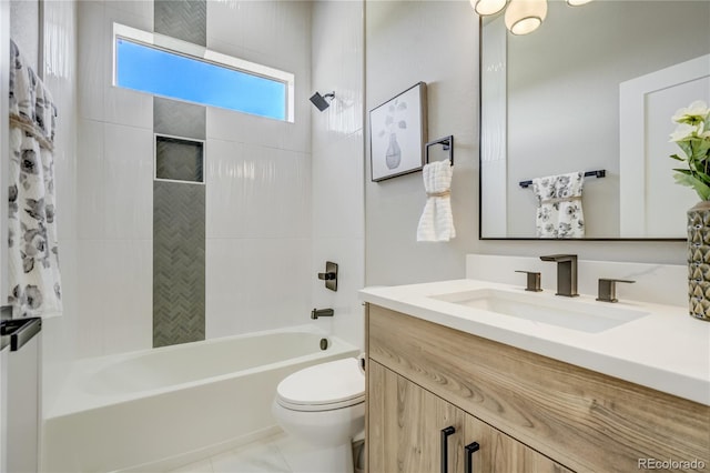 full bathroom with toilet, tiled shower / bath, vanity, and tile patterned floors