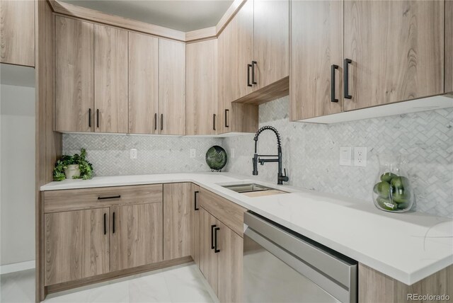 kitchen featuring sink, decorative backsplash, light brown cabinets, and dishwasher