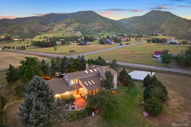 aerial view at dusk featuring a mountain view