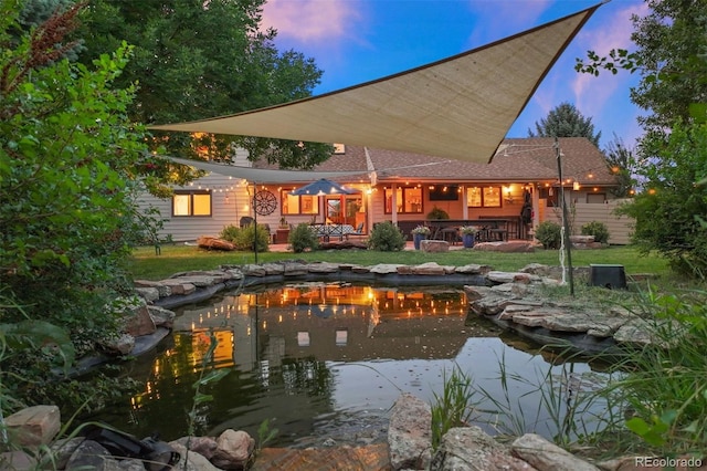 pool at dusk featuring a lawn