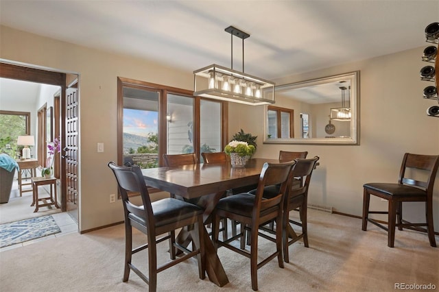 carpeted dining area with plenty of natural light